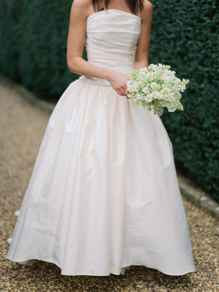  Bride holding white bouquet at Sudeley Castle wedding